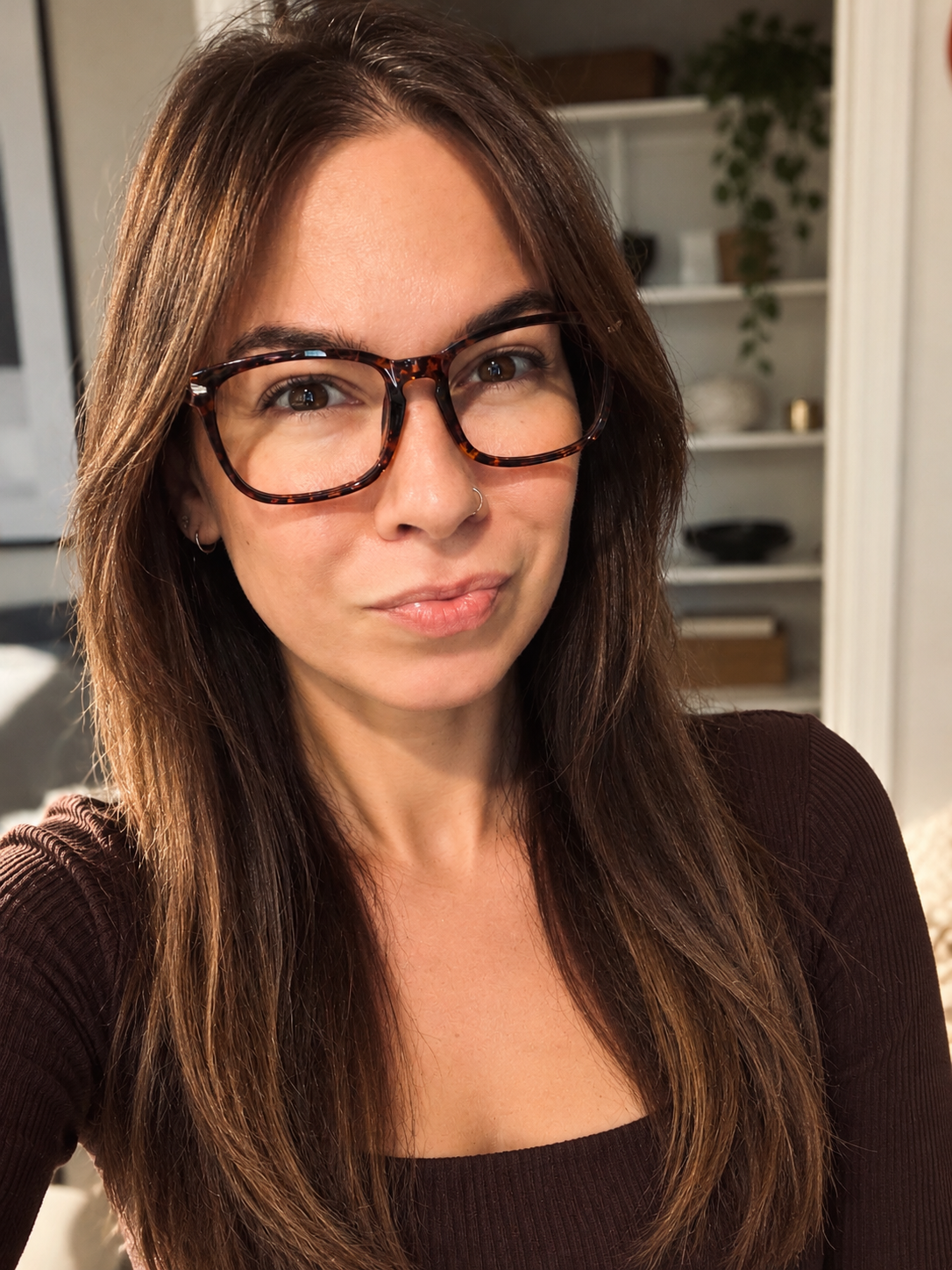 Teesha, founder of Mercury House Media, wearing tortoiseshell glasses